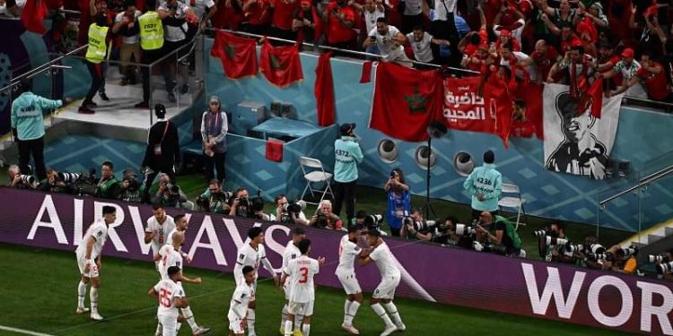 Morocco's midfielder #11 Abdelhamid Sabiri (R) celebrates with his teammates after he scored his team's first goal during the Qatar 2022 World Cup Group F football match between Belgium and Morocco at the Al-Thumama Stadium in Doha on November 27, 2022. (Photo by Kirill KUDRYAVTSEV / AFP)